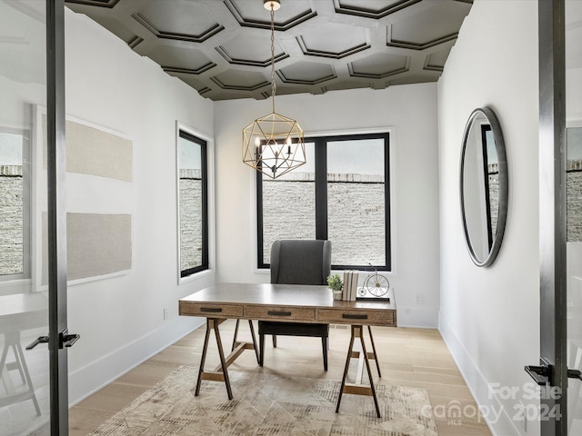 office area with an inviting chandelier, light wood-type flooring, french doors, and coffered ceiling