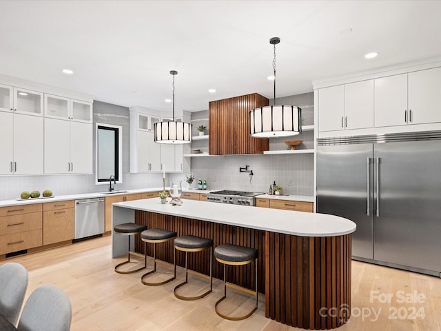 kitchen with white cabinetry, light hardwood / wood-style flooring, stainless steel appliances, and backsplash