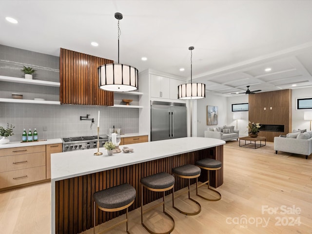 kitchen with stainless steel built in refrigerator, light wood-type flooring, backsplash, ceiling fan, and stove