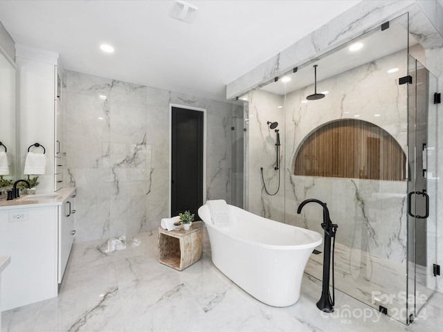 bathroom with shower with separate bathtub, vanity, tile patterned flooring, and tile walls