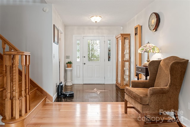 tiled foyer featuring a textured ceiling