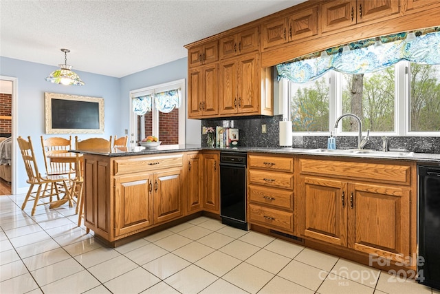 kitchen with light tile patterned floors, backsplash, sink, and kitchen peninsula