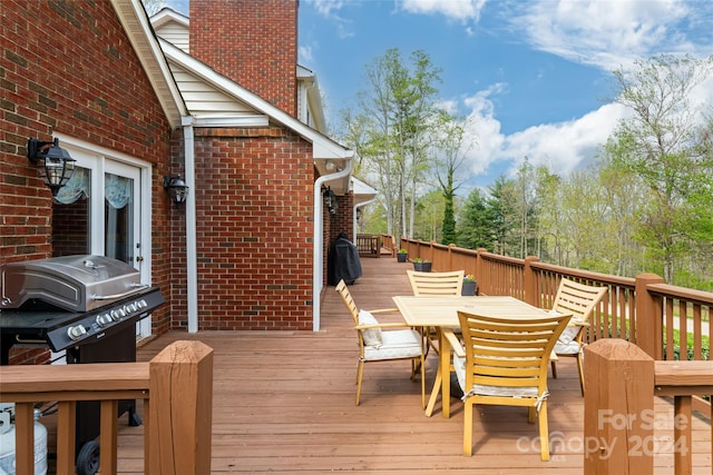 wooden terrace featuring a grill