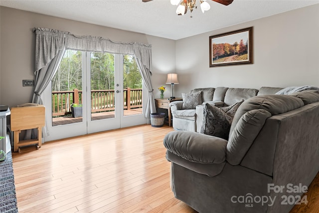 living room with light wood-type flooring, ceiling fan, and french doors