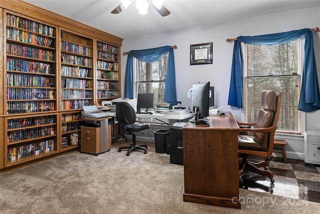 office area with a textured ceiling and carpet floors