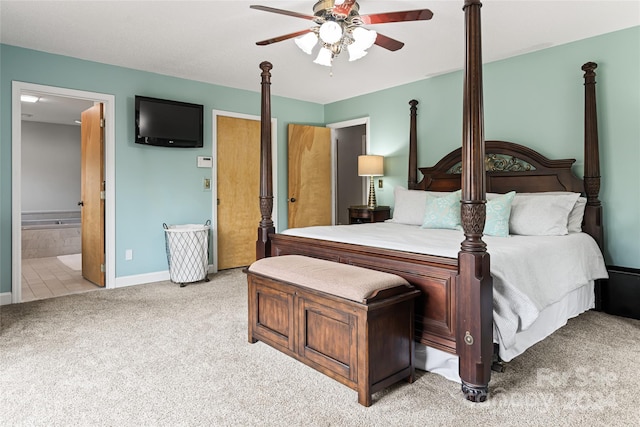 carpeted bedroom with ceiling fan and ensuite bath