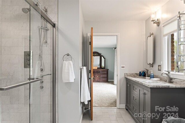 bathroom featuring tile patterned floors, walk in shower, and vanity