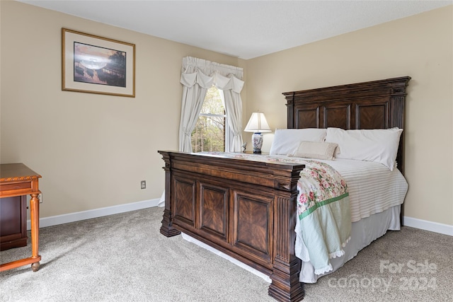 bedroom featuring light carpet