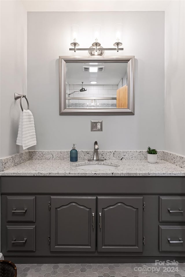 bathroom featuring tile patterned flooring and vanity