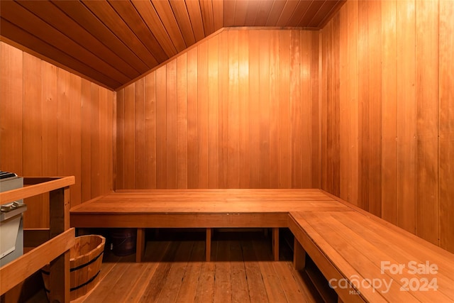 view of sauna / steam room featuring hardwood / wood-style floors, wood walls, and wooden ceiling