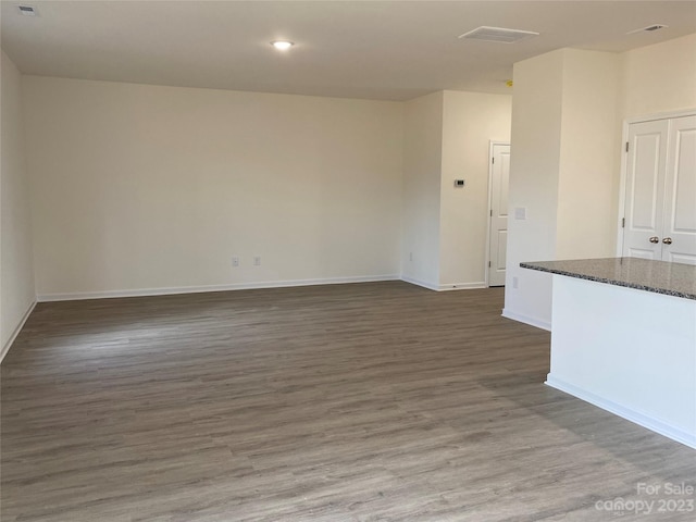 unfurnished living room featuring dark hardwood / wood-style floors