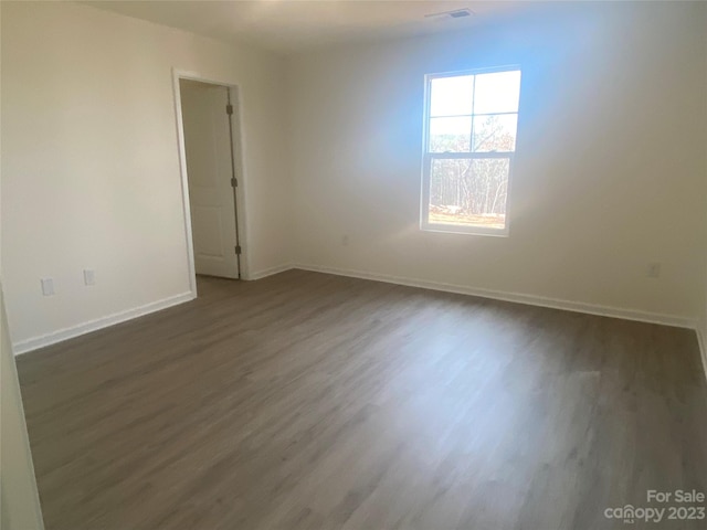 spare room with dark hardwood / wood-style flooring