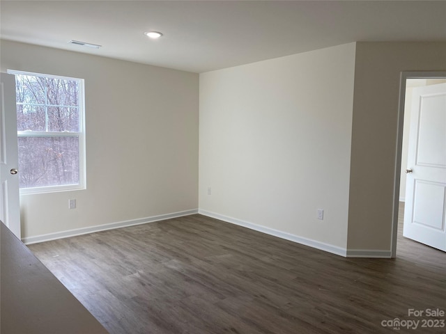 unfurnished room with dark hardwood / wood-style floors