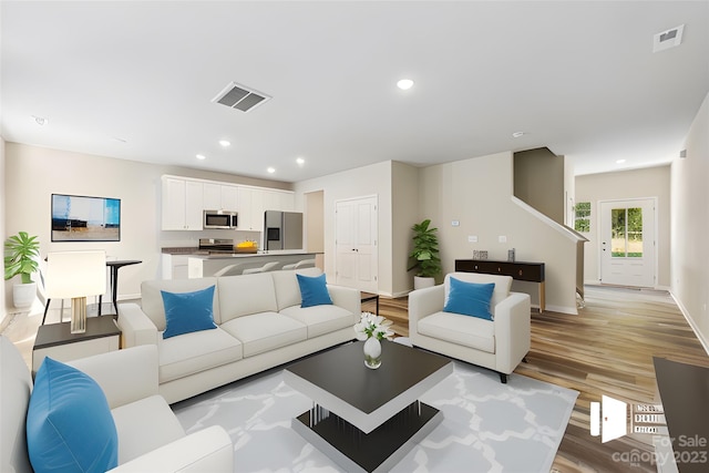 living room with light hardwood / wood-style flooring