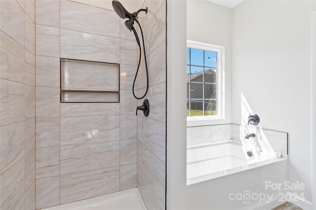 bathroom featuring shower with separate bathtub