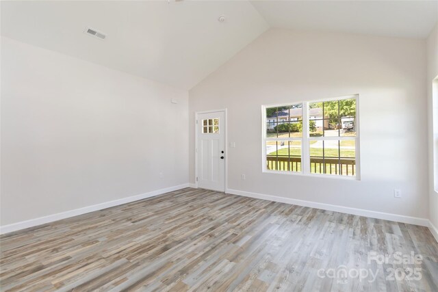 213 Sheffield Dr, York, SC 29745 - empty room with high vaulted ceiling, light wood finished floors, and baseboards