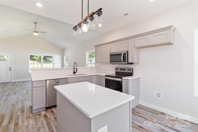 213 Sheffield Dr, York, SC 29745 - kitchen featuring appliances with stainless steel finishes, a sink, gray cabinets, a peninsula, and light countertops