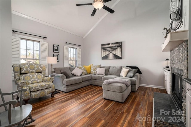 living room featuring a tile fireplace, ceiling fan, ornamental molding, and dark hardwood / wood-style flooring