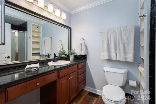 bathroom featuring crown molding, hardwood / wood-style floors, toilet, walk in shower, and vanity