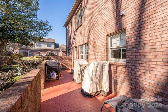 wooden terrace with grilling area and a patio