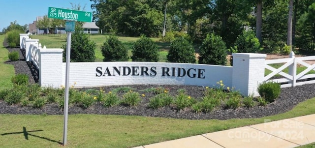 community / neighborhood sign with a lawn