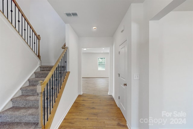 stairway featuring hardwood / wood-style flooring