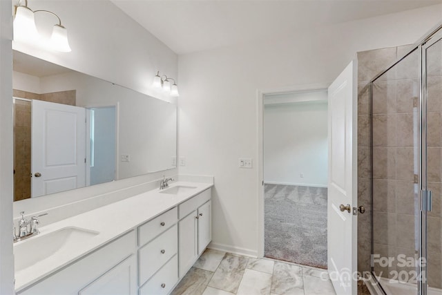 bathroom with vanity and a shower with shower door