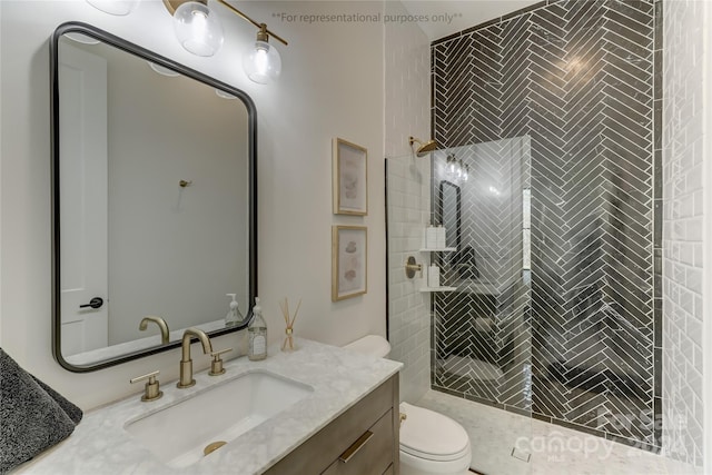 bathroom featuring vanity, a tile shower, and toilet