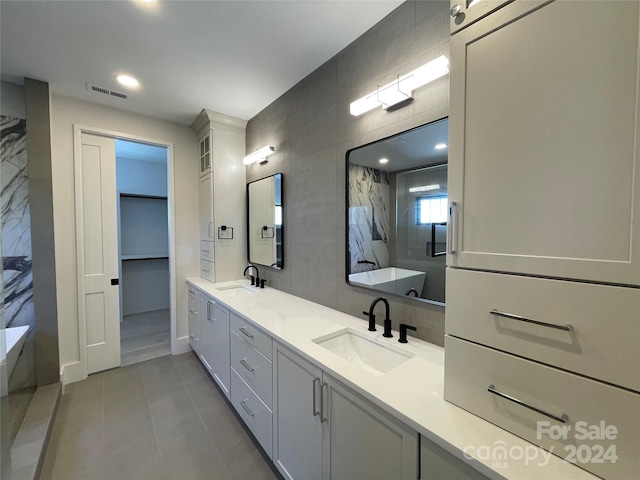 bathroom featuring vanity, tile patterned floors, and tile walls