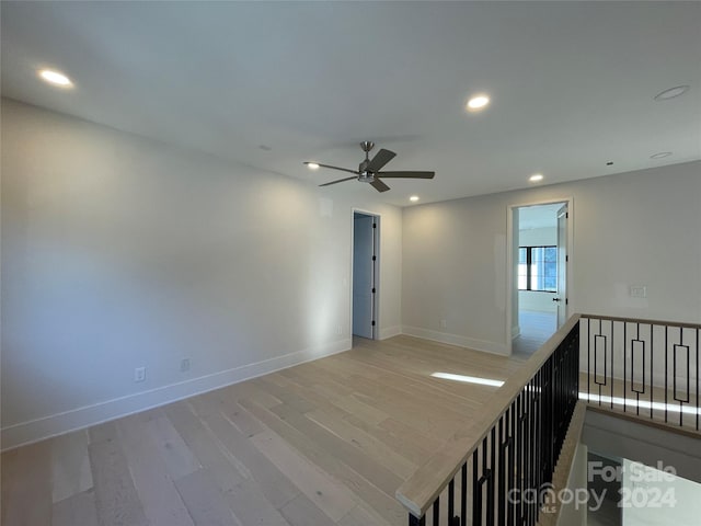 spare room featuring ceiling fan and light wood-type flooring