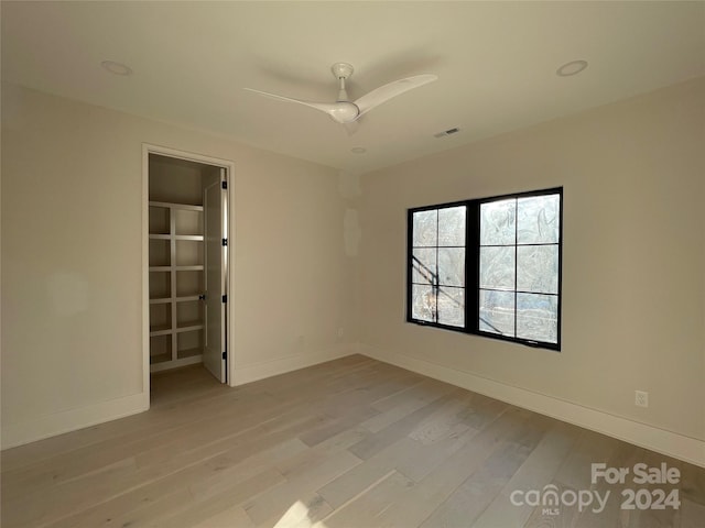 spare room featuring ceiling fan and light wood-type flooring