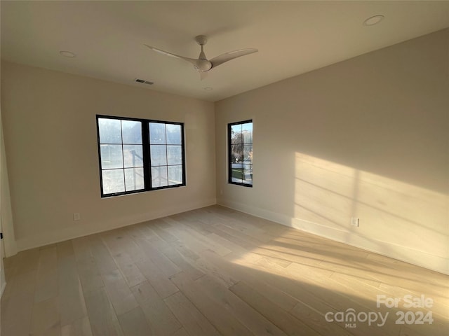 empty room featuring ceiling fan and light hardwood / wood-style flooring