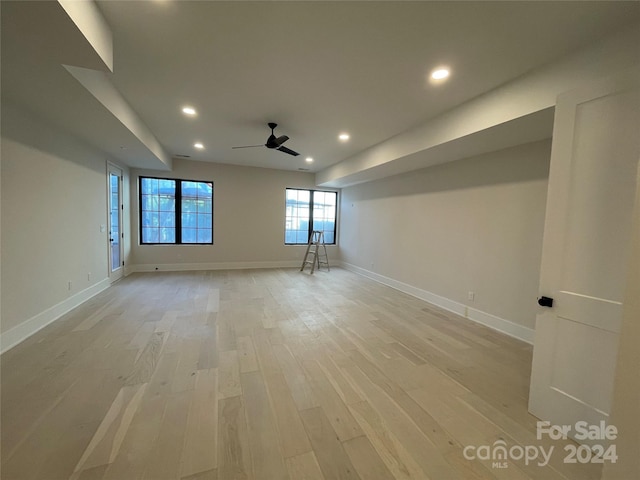 spare room with ceiling fan and light wood-type flooring