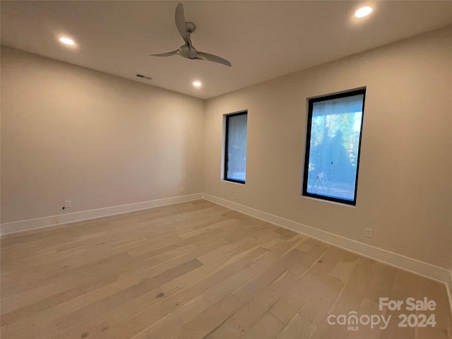 spare room featuring hardwood / wood-style flooring and ceiling fan