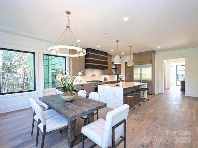 dining area featuring hardwood / wood-style flooring and a notable chandelier