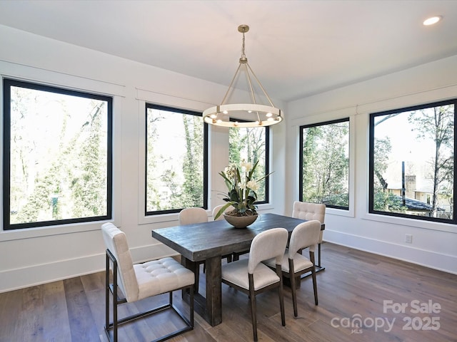 dining area featuring dark hardwood / wood-style floors and a notable chandelier