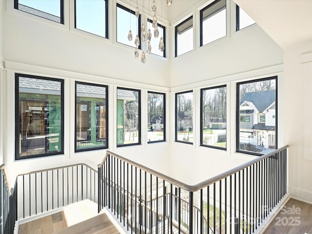 interior space featuring wood-type flooring and a high ceiling