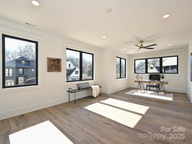 interior space with ceiling fan and dark hardwood / wood-style flooring