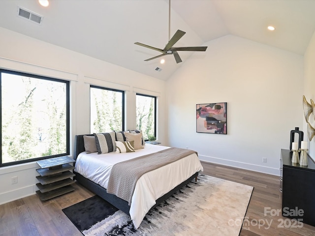 bedroom with ceiling fan, dark hardwood / wood-style flooring, and high vaulted ceiling