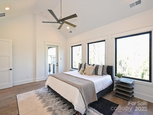 bedroom featuring dark hardwood / wood-style flooring, high vaulted ceiling, and ceiling fan