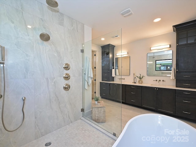 bathroom with vanity, tile patterned floors, and plus walk in shower