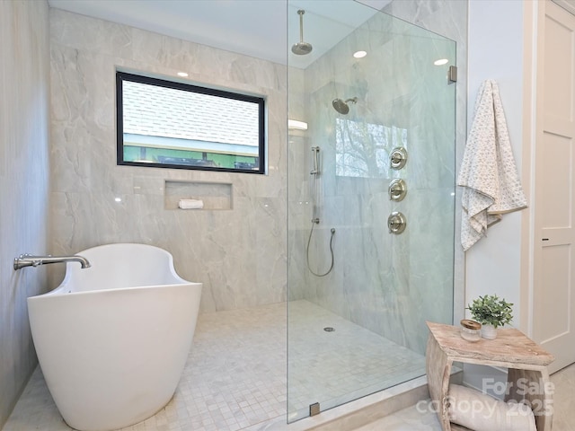 bathroom with shower with separate bathtub