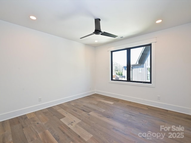 unfurnished room with ceiling fan and wood-type flooring