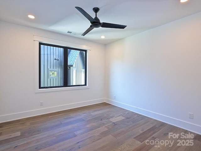 unfurnished room featuring dark hardwood / wood-style flooring and ceiling fan