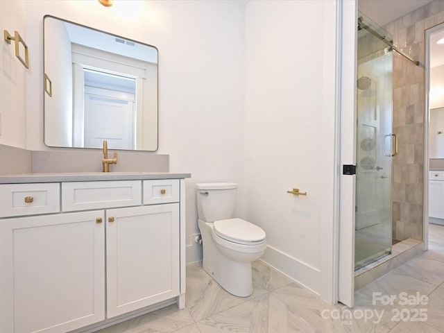 bathroom with vanity, toilet, and an enclosed shower