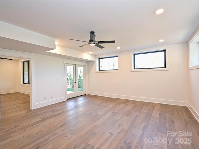 unfurnished room featuring hardwood / wood-style flooring, ceiling fan, and french doors