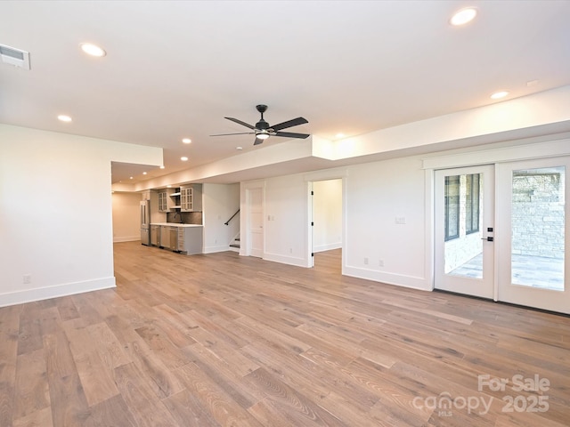 unfurnished living room featuring light hardwood / wood-style floors and ceiling fan