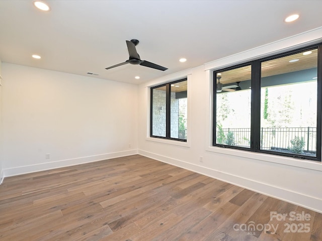 empty room with wood-type flooring and ceiling fan