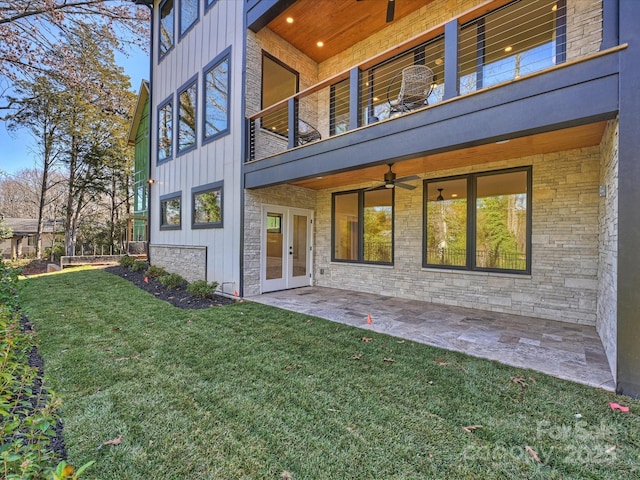 back of house featuring french doors, a patio area, a balcony, a lawn, and ceiling fan