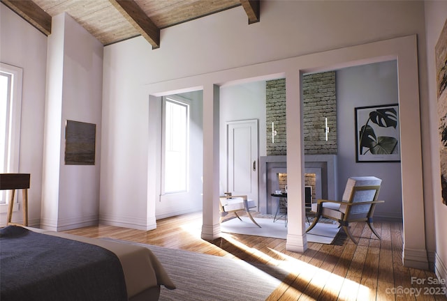 bedroom featuring a fireplace, brick wall, light hardwood / wood-style floors, lofted ceiling with beams, and wood ceiling